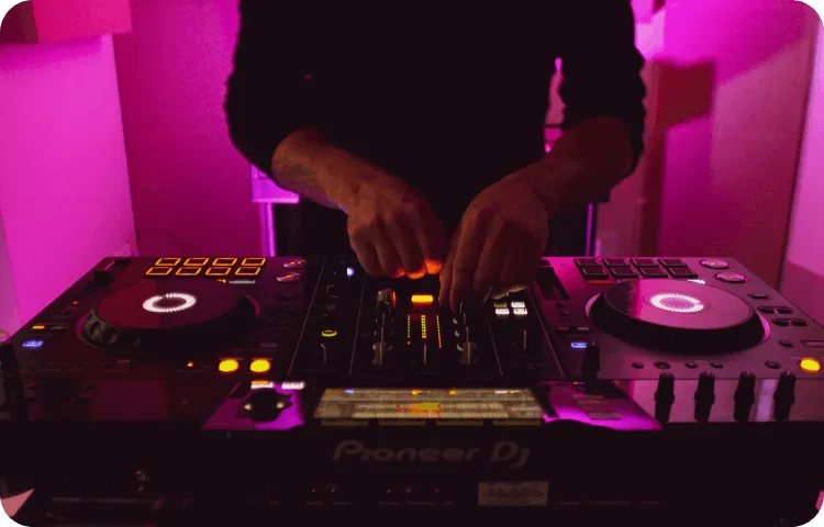 Photo of a DJ with a pink background